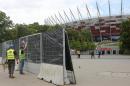 Workers install fences around the National Stadium, the venue of the upcoming NATO summit, in Warsaw, Poland, Wednesday, July 6, 2016. The Polish capital will host a two-day NATO summit starting Friday, the first time ever that it hosts a top-level meeting of the Western military alliance which it joined in 1999. (AP Photo/Czarek Sokolowski)