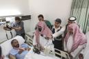 Abdul Rahman Al Sudais, Imam of the Grand Mosque in Mecca, visits one of the victims of the crane accident at the mosque at Al Nour specialist hospital in Mecca, Saudi Arabia, Sunday, Sept. 13, 2015. High winds were to blame for the toppling of a massive crane that smashed into the mosque and killed over 100 people ahead of the start of the annual hajj pilgrimage, the head of Saudi Arabia's civil defense directorate said Saturday. (AP Photo/Mosa'ab Elshamy)