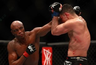 Anderson Silva punches at Nick Diaz in their middleweight bout at UFC 183. (Getty)