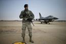 A U.S. soldier stands guard in front of their Air F-16 fighter jet at Osan Air Base in Pyeongtaek