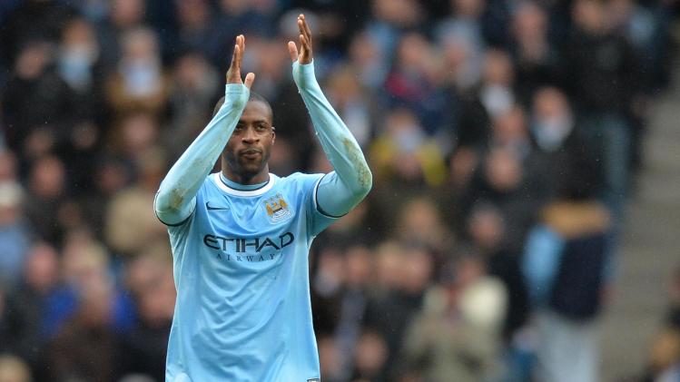 Manchester City midfielder Yaya Toure celebrates after scoring his team&#39;s third goal and completing his hat-trick during an English Premier League match at the Etihad Stadium in Manchester, north-west England, on March 22, 2014