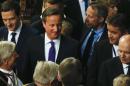 Britain's Prime Minister David Cameron, centre, talks to colleagues after Britain's Queen Elizabeth II delivered the Queen's Speech to the House of Lords in the Palace of Westminster during the State Opening of Parliament in London, Wednesday, May 27, 2015. The Queens Speech outlines her governments legislative plans for the forthcoming parliamentary year and the laws and bills they hope to pass. (AP Photo/Alastair Grant, Pool)