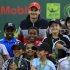 File photo of Roger Federer of Switzerland posing with children during the opening of the Qatar Open tennis tournament in Doha