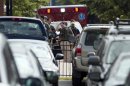 Heavily armed U.S. marshals walk from the Washington Navy Yard after a shooting by multiple gunmen in Washington