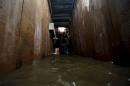 A journalist films inside a tunnel connected from a house to the city's drains used by the drug lord Joaquin "El Chapo" Guzman to escape during an operation to recapture him in Los Mochis
