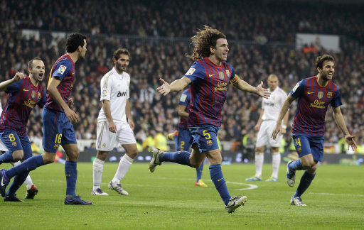 FC Barcelona's Carles Puyol, center right, celebrates after scoring against Real Madrid during a Copa del Rey quarterfinal, first leg soccer match at the Bernabeu stadium in Madrid, Wednesday, Jan. 18, 2012. Barcelona won 2-1. (AP Photo/Paul White)