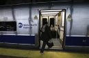 A woman boards the first Metro North commuter train to leave Grand Central Station in New York since 7pm EDT on Sunday October 28 as some service was resumed following Hurricane Sandy