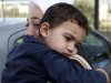 Bushr Al Tawashi, as he is carried by his mother Arin Al Dakkar, outside of a private Sigma TV station, in Nicosia, Cyprus, Friday, Oct. 26, 2012. A 2-year-old Syrian boy who was believed dead after his family inadvertently left him behind as they fled shelling in Damascus last summer has been reunited with his parents in Cyprus, a lawyer said. "You can imagine how they felt when they were told their son was alive after bearing all this guilt thinking that he was dead," lawyer Stella Constantinou told The Associated Press. (AP Photo/Petros Karadjias)