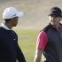 Rory McIlroy from Northern Ireland, rear, and Tiger Woods from U.S. talk on the 13th hole during the first round of Abu Dhabi Golf Championship in Abu Dhabi, United Arab Emirates, Thursday, Jan. 17, 2013. (AP Photo/Kamran Jebreili)