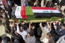 Mourners carry a coffin draped with Iraqi flags during the funeral procession for Shaima Alawadi in the Shiite holy city of Najaf, 100 miles (160 kilometers) south of Baghdad, Iraq, Saturday, March 31, 2012. Alawadi was an Iraqi-American woman found bludgeoned to death in her California home last week, with a threatening note left beside her body, was buried in her native Iraq on Saturday. (AP Photo/Hadi Mizban)