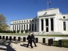 Pedestrians walk past the Federal Reserve Building in Washington
