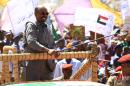 Sudan's President Omar al-Bashir (C) waves to the crowd during a campaign rally for the upcoming presidential elections in El-Fasher, in North Darfur, on April 8, 2015