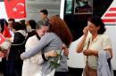 Employee at Turkey's consulate in Mosul is welcomed by her relatives at Esenboga airport in Ankara