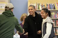 U.S. President Barack Obama shakes hands with a man next to his daughter Malia at One More Page bookstore in Arlington, Virginia, November 24, 2012. REUTERS/Yuri Gripas