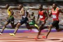 Jamaica's Usain Bolt, left, leads in a men's 100-meter heat during the athletics in the Olympic Stadium at the 2012 Summer Olympics, London, Saturday, Aug. 4, 2012. (AP Photo/David J. Phillip)