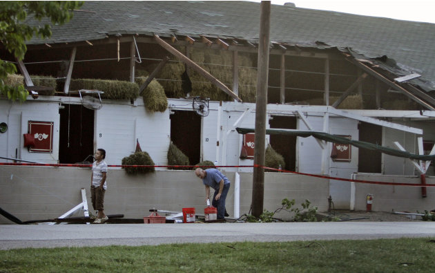 Workers clean up in the stable area at Churchill Downs in Louisville, Ky. Thursday, June 23, 2011 following a possible tornado touchdown at the race track on Wednesday night. Although at least nine ba