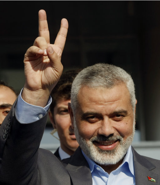 The Gaza Strip's Hamas Premier Ismail Haniyeh makes a victory sign after a meeting with a Turkish leader in Ankara, Turkey, Tuesday, Jan. 3, 2012. Haniyeh visited the Mavi Marmara, the ship that was the target of a deadly raid by Israeli troops seeking to prevent an aid flotilla reaching the Palestinian territory, in Istanbul on Monday. Haniyeh's visit was a show of solidarity with the Islamic aid group IHH, which had planned to send the Mavi Marmara vessel with another Gaza flotilla last year but then dropped the plan.(AP Photo/Burhan Ozbilici)