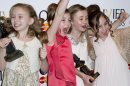 From left, Best Actress in a Musical winners, Sophia Kiely, Eleanor Worthington Cox, Kerry Ingram and Cleo Demetriou of Matilda The Musical pose in the press room at the Olivier Awards at the Royal Opera House, London, Sunday, April 15, 2012. (AP Photo/Jonathan Short)