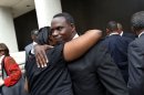 Sherrel Johnson, mother of James Brisette, who was killed by New Orleans police, is hugged by Rev. Aubrey Wallace outside Federal Court after sentences were handed out in the case in New Orleans, Wednesday, April 4, 2012. Five former New Orleans police officers were sentenced Wednesday to prison terms ranging from six to 65 years for their roles in deadly shootings of unarmed residents in the chaotic days after Hurricane Katrina, with the judge lashing out at prosecutors for two hours on their handling of the case. (AP Photo/Gerald Herbert)