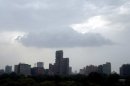 Rain clouds gather above the skyline of New Delhi