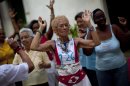 In this picture taken Aug 2, 2012, women dance at a senior center, that provides retirees with medical attention, meals and social activities, in Havana, Cuba. Cuba grapples with having the oldest citizenry in Latin America, a phenomenon fueled by low birth rates and long life expectancies, plus the migration of young people and women. The government has already postponed the retirement age and is trying to create more homes and programs for the elderly, but still will have to handle the economic consequences of its increasingly graying population.(AP Photo/Ramon Espinosa)