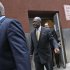 Republican presidential candidate Herman Cain is escorted by security as he leaves the back door of the Russian Tea Room after a fundraiser,  Friday, Nov. 11, 2011, in New York.  (AP Photo/Mary Altaffer)