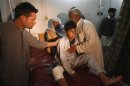 A boy, injured in a bomb blast waits for treatment at a hospital in Peshawar