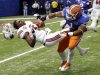Florida linebacker Jon Bostic (1) hits Louisville quarterback Teddy Bridgewater (5) hard enough to dislodge his helmet in the first quarter of the Sugar Bowl NCAA college football game Wednesday, Jan. 2, 2013, in New Orleans. (AP Photo/Bill Haber)