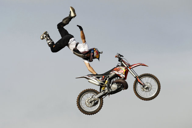 A stunt rider of Red Bull X-Fighters performs during a show in Colombo, Sri Lanka, Saturday, July 30, 2011. The Red Bull X-Fighters is one of the biggest Freestyle Motocross Championship riders in the