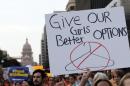 Protesters carry signs during an abortion rights march in Austin