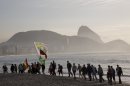 Backdropped by Sugar Loaf mountain, a group walks along the Copacabana beach on their way to attend the World Youth Day's closing Mass, in Rio de Janeiro, Brazil, Sunday, July 28, 2013. An estimated 3 million people poured onto Rio's Copacabana beach on Sunday for the final Mass of Pope Francis' historic trip to his home continent, cheering the first Latin American pope in one of the biggest turnouts for a papal Mass in recent history. (AP Photo/Andre Penner)