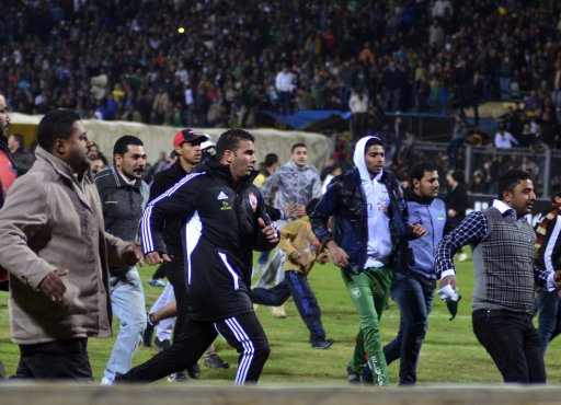 Football fans try to leave the stadium as chaos erupts at a soccer stadium in Port Said city