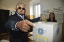 Co-founder of 5-Star Movement Beppe Grillo casts his ballot for a referendum on the duration of offshore drilling concessions, in Rome, Sunday, April 17, 2016. Italians are voting in a referendum on the duration of offshore drilling concessions in territorial waters, as nine regional governments seek to wrestle some influence over energy policy away from the central government in Rome. (Luca Zennaro/ANSA via AP)