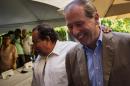 U.S. Senator Tom Udall, right, walks with U.S. senator Raul Grijalba, left, after a press conference in Havana, Cuba, Wednesday, May 27, 2015. Udall, a New Mexico Democrat who led a four-member Democratic congressional delegation to Cuba, all supporters of lifting the embargo on Cuba, said there appears to be growing momentum to removing at least elements of it, such as the ban on travel. (AP Photo/Ramon Espinosa)