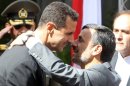 Mahmoud Ahmadinejad (R) greets Bashar al-Assad during a welcoming ceremony in Tehran on October 2, 2010