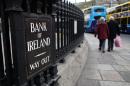 File photo shows shoppers passing the Bank of Ireland building in Dublin on December 11, 2013