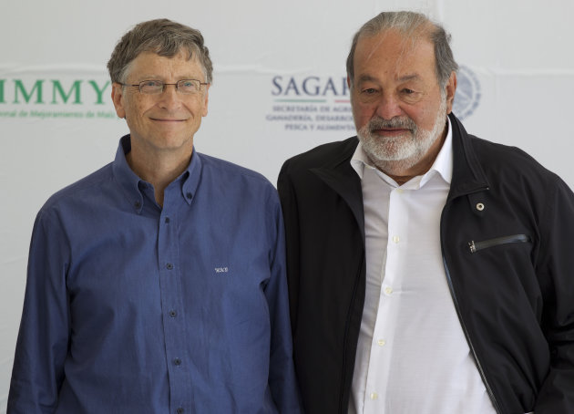 Microsoft Chairman Bill Gates, left, and Mexican telecommunications tycoon Carlos Slim poses for photographers during the inauguration of the new research center at the International Center for Improvement of Corn and Wheat (CIMMYT) in Texcoco, Mexico, Wednesday, Feb. 13, 2013. Gates and Slim teamed up to to fund new seed breeding research which the CIMMYT says aims to sustainably increase the productivity of maize and wheat systems to ensure global food security and reduce poverty. (AP Photo/Eduardo Verdugo)