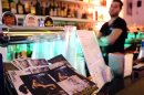 A bartender looks on in the "Coming Out" bar, Rome's best known gay bar, next to the Colosseum in downtown Rome