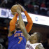 New York Knicks' Carmelo Anthony (7) shoots over Cleveland Cavaliers' Alonzo Gee in the third quarter of an NBA basketball game on Friday, April 12, 2013, in Cleveland. Anthony scored 31 points in the Knicks' 101-91 win. (AP Photo/Mark Duncan)