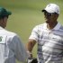In this April 5, 2010, photo, Tiger Woods shakes hands with Fred Couples' caddie, Joe LaCava, during a practice round for the Masters golf tournament in Augusta, Ga. Woods has hired LaCava to be his caddie. Two people aware of the deal told The Associated Press on Sunday, Sept. 25, 2011, that LaCava decided to leave Dustin Johnson, one of the most talented young Americans, to go to work for Woods. (AP Photo/David J. Phillip)