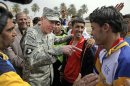 FILE - In this March 1, 2008 file photo, then-top U.S. commander in Iraq, Gen. David Petraeus, center left, talks to players during a youth soccer tournament in central Baghdad, Iraq. Petraeus, the retired four-star general who led the U.S. military campaigns in Iraq and Afghanistan, resigned Friday, Nov. 9, 2012 as director of the CIA after admitting he had an extramarital affair. (AP photo/Dusan Vranic, File)