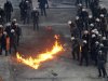 A petrol bomb explodes in front of riot police officers during clashes in front of the Greek parliament, Athens, Sunday, Feb. 12, 2012. (AP Photo/Kostas Tsironis)
