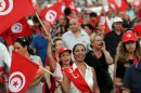 Tunisian demonstrators wave their national flag during a demonstration in Tunis on August 24, 2013