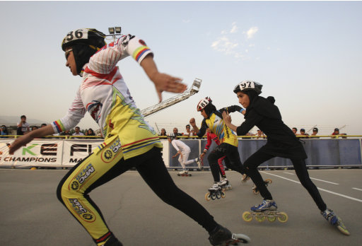 Iranian female rollerbladers start their competition, during women's rollerblading championship league, at the Azadi (Freedom) sport complex, in Tehran, Iran, Thursday, June 30, 2011. (AP Photo/Vahid Salemi)