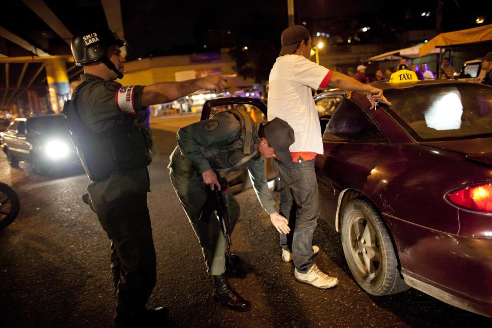 In this May 14, 2013 photo, a National Guard soldier frisks a man outside his car at a checkpoint that is part of the "Secure Homeland" initiative in ...