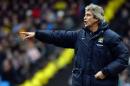 Manchester City's manager Manuel Pellegrini gestures to players during an English FA Cup match at the Etihad Stadium in Manchester on January 25, 2014