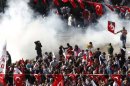 Demonstrators run as police use tear gas to disperse them in central Ankara