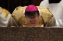 Archbishop Blase Cupich kisses a bible during his Installation Mass at Holy Name Cathedral, Tuesday, Nov. 18, 2014, in Chicago. Cupich was named in September by Pope Francis to succeed the retiring Cardinal Francis George. (AP Photo/Charles Rex Arbogast, Pool)