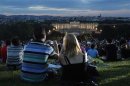A couple take a photo as they attend the Summer Night Concert of the Vienna Philharmonic Orchestra in Vienna