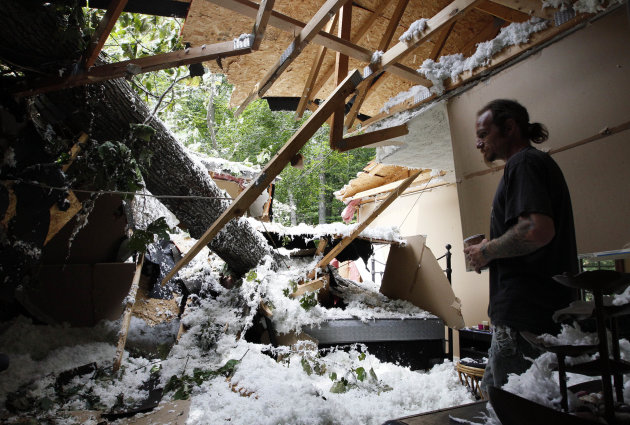 Chester Vickers surveys the bedroom of his girlfriend's daughter, which was heavily damaged by a tree that fell in high winds caused by Hurricane Irene in Port Deposit, Md., Monday, Aug. 29, 2011. (AP
